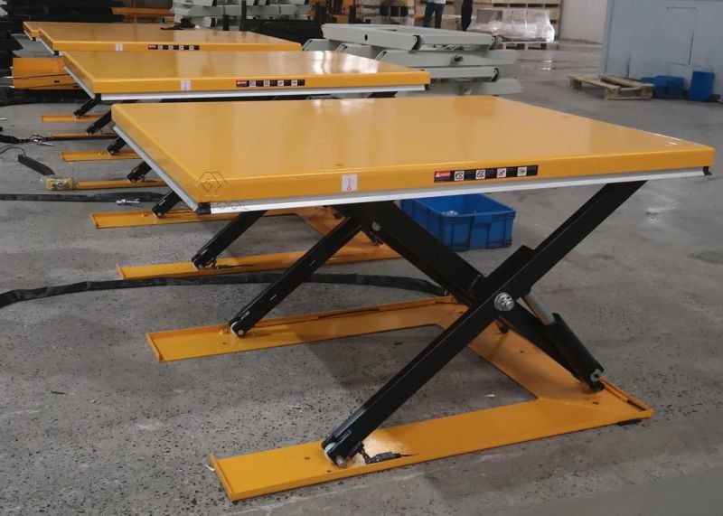 Low-Profile Powered Lift Table with Access Ramp to Load-Unload Palets Without a Pit