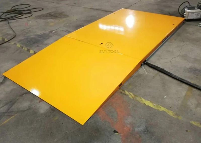 Low-Profile Powered Lift Table with Access Ramp to Load-Unload Palets Without a Pit
